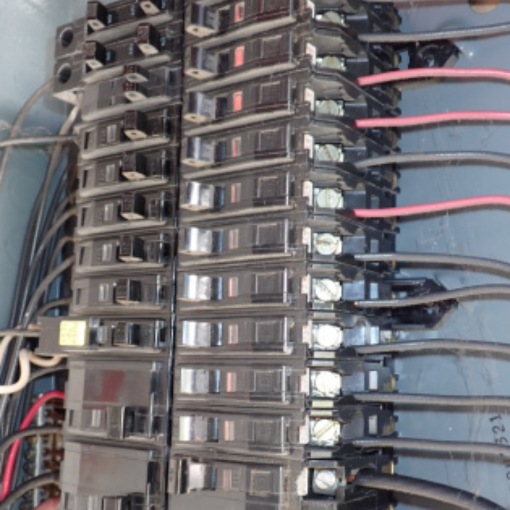 Certified home inspector checking electrical panel during a 4 point home inspection