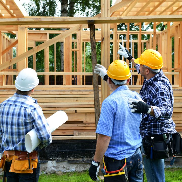 construction workers looking at a new home being built before a home inspection
